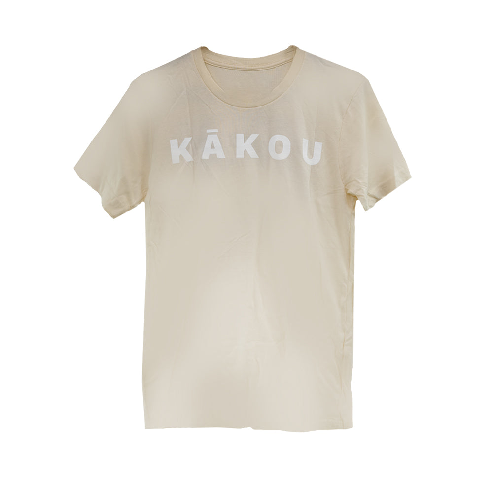 Beige t-shirt with the word "KĀKOU" printed in large white capital letters across the chest. The shirt has a simple and clean design with a classic crew neckline.