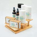 Natural skincare products display featuring Bluebird Naturals deodorant, bug spray, and handmade soap, and Blakbird organic soap on a wooden stand, eco-friendly personal care items for sensitive skin.